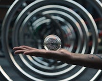 a person holding a glass ball in their hand